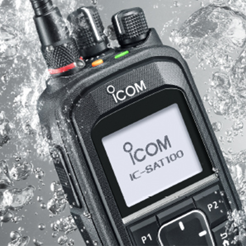 ICOM radio communication device with water droplets on a gray background